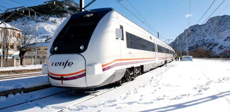 Train at a station covered in snow