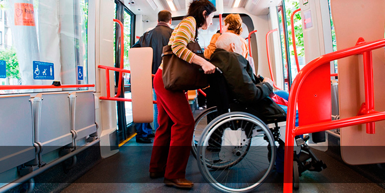 Passenger pushing a wheelchair, getting off the train